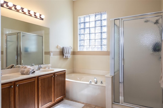 bathroom featuring tile patterned floors, vanity, and shower with separate bathtub