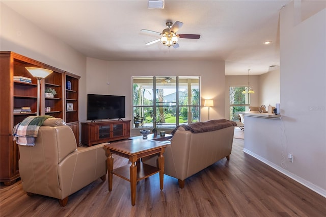 living room with ceiling fan and dark hardwood / wood-style floors