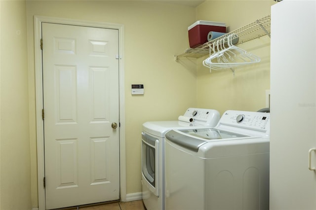 clothes washing area featuring separate washer and dryer and light tile patterned flooring