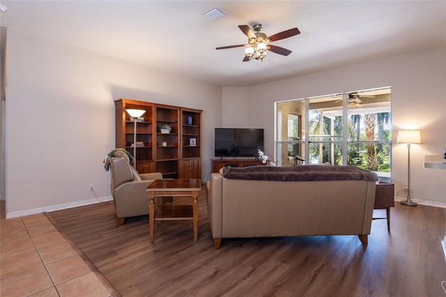 living room featuring ceiling fan and hardwood / wood-style floors