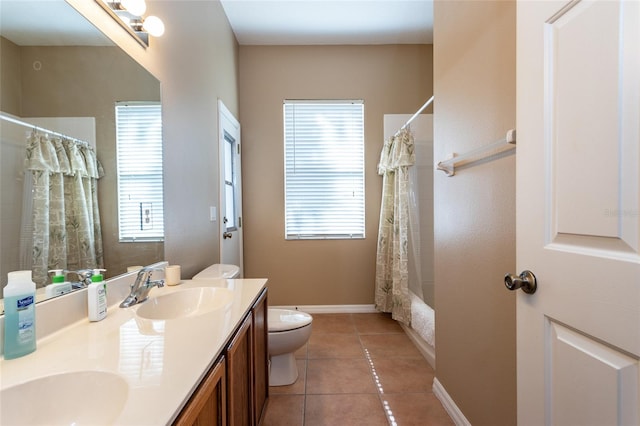 full bathroom with tile patterned flooring, vanity, a wealth of natural light, and toilet