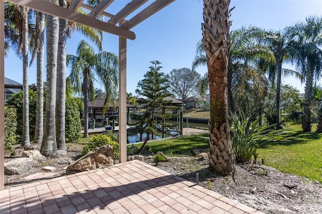 view of patio featuring a water view and a pergola