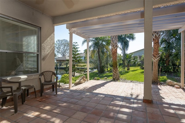 view of patio featuring a pergola and a water view