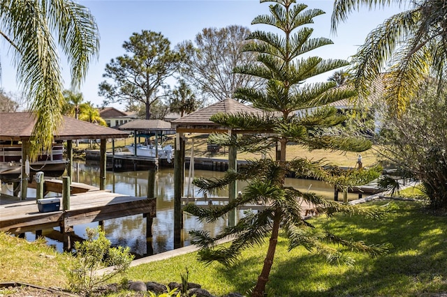 dock area featuring a yard and a water view