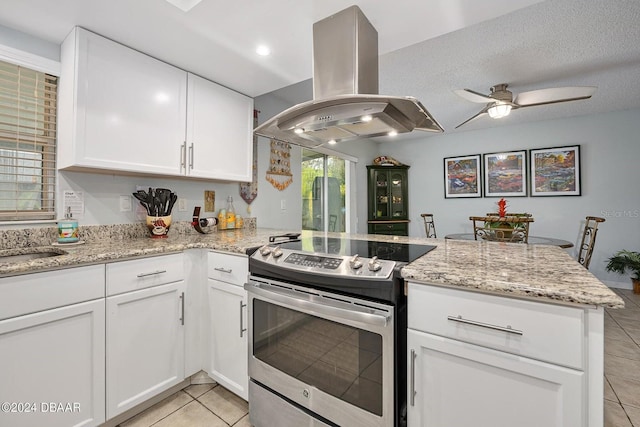 kitchen with white cabinetry, light tile patterned floors, electric range, kitchen peninsula, and island exhaust hood