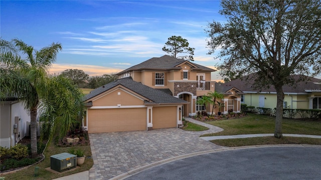 view of front facade featuring a garage, a lawn, and a balcony