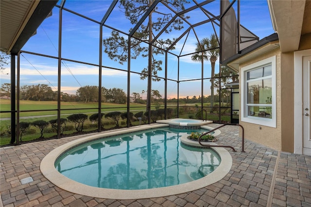 view of pool with an in ground hot tub, a lanai, and a patio area