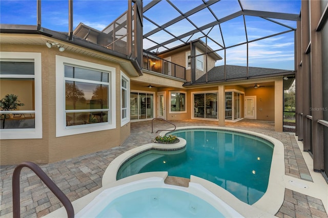 view of pool featuring a patio, ceiling fan, and glass enclosure