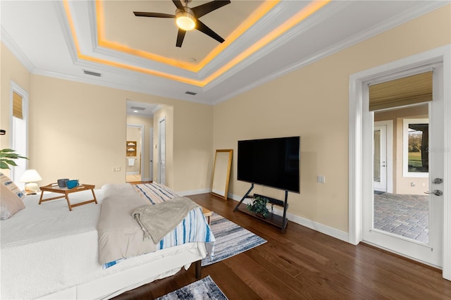 living room featuring dark hardwood / wood-style flooring, ornamental molding, a raised ceiling, and ceiling fan