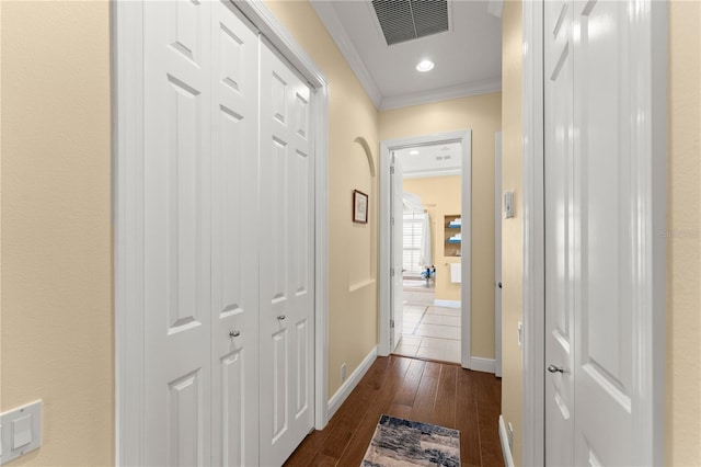 hallway with crown molding and dark wood-type flooring