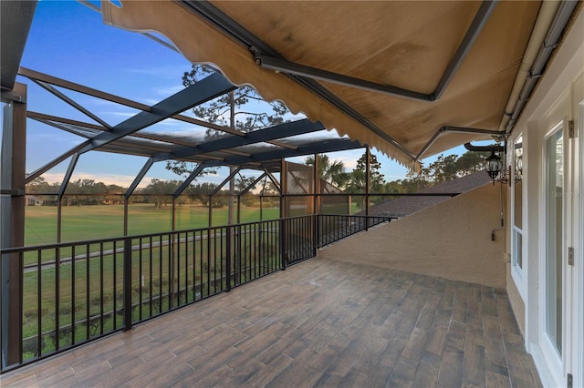 patio terrace at dusk featuring a lawn