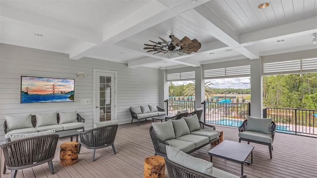 wooden deck with ceiling fan, outdoor lounge area, and a fenced in pool