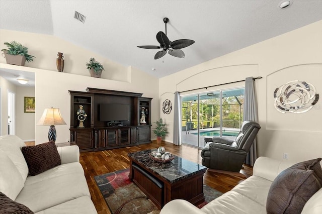 living room featuring vaulted ceiling, dark hardwood / wood-style floors, and ceiling fan