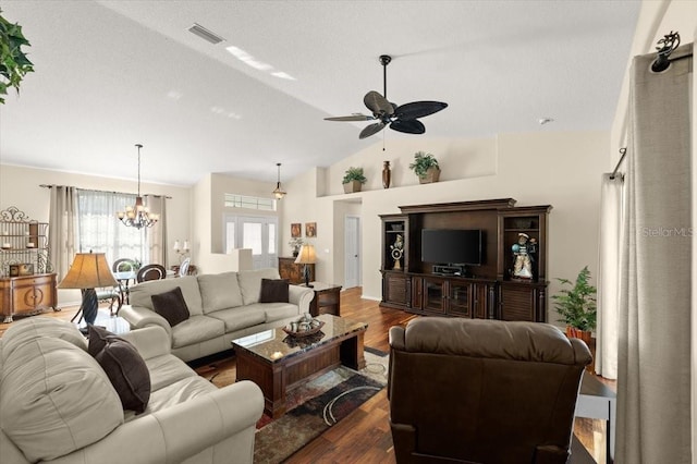 living room with dark wood-type flooring, lofted ceiling, and ceiling fan with notable chandelier