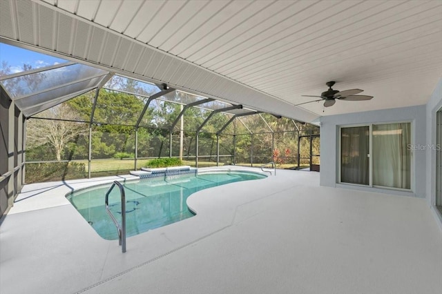 view of pool with a patio, ceiling fan, and glass enclosure