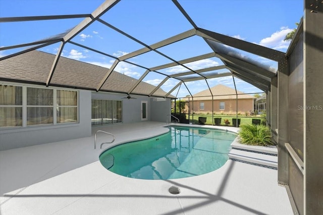 view of swimming pool featuring a patio area and glass enclosure