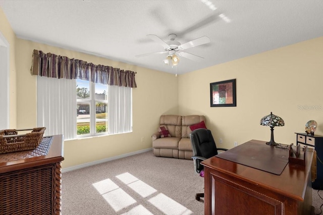 home office featuring light carpet and ceiling fan