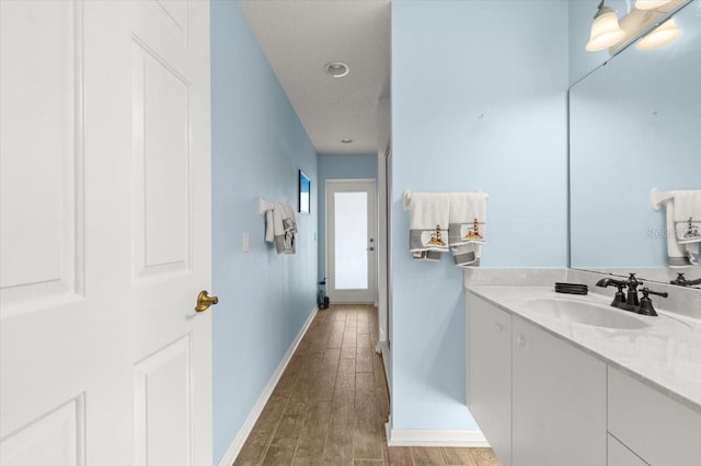 bathroom with vanity and hardwood / wood-style floors