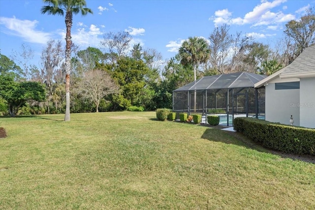 view of yard with glass enclosure