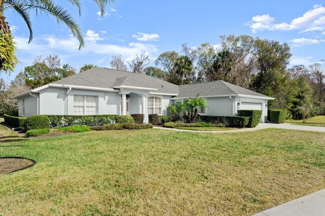 single story home featuring a garage and a front lawn