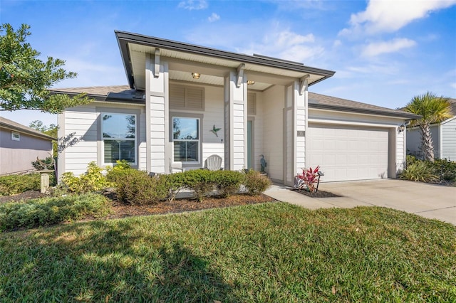 view of front of property with a garage and a front lawn