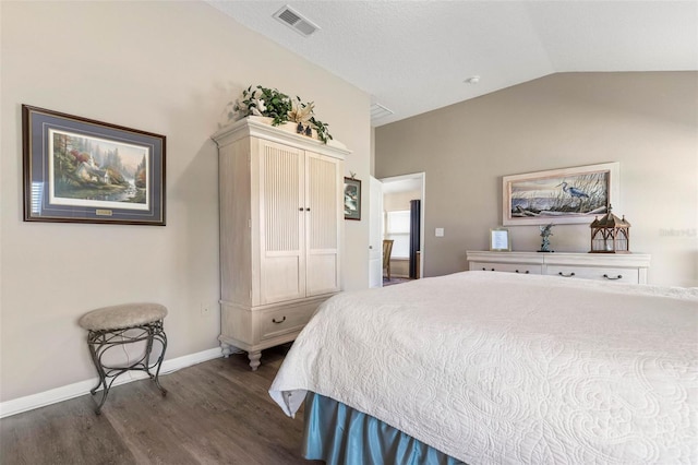 bedroom featuring lofted ceiling and dark wood-type flooring