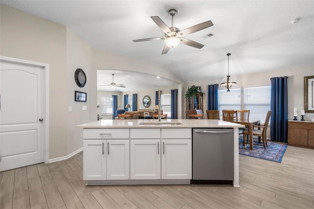 kitchen featuring sink, decorative light fixtures, a center island with sink, stainless steel dishwasher, and white cabinets