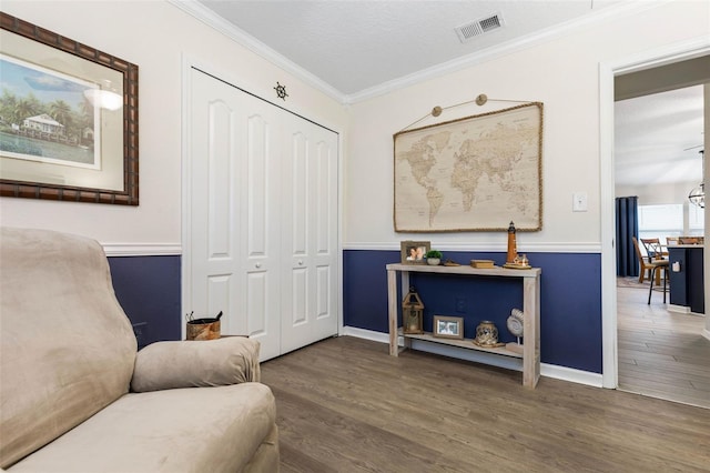 sitting room featuring crown molding, dark hardwood / wood-style floors, and a textured ceiling