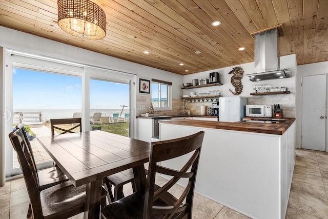 dining room featuring bar, wood ceiling, and a water view