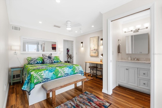 bedroom with connected bathroom, wood-type flooring, sink, ornamental molding, and ceiling fan