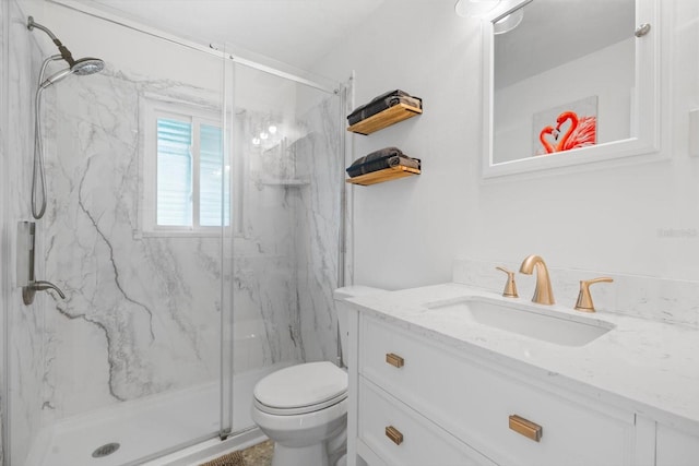 bathroom featuring vanity, toilet, and a shower with door