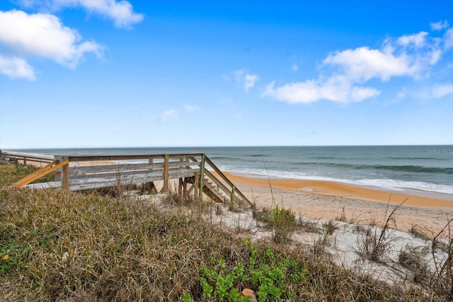 exterior space with a water view and a view of the beach