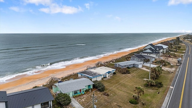 birds eye view of property featuring a water view and a view of the beach