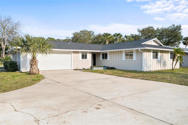 ranch-style home with a garage and a front lawn