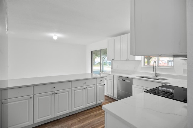 kitchen with white cabinetry, dishwasher, sink, and a wealth of natural light