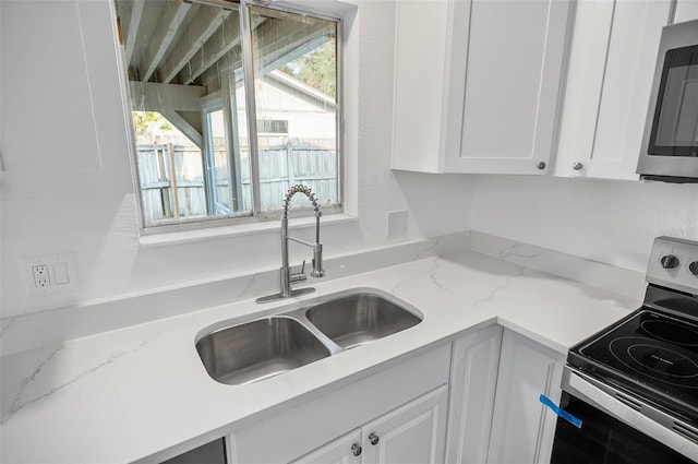 kitchen featuring sink, a wealth of natural light, stainless steel appliances, and white cabinets