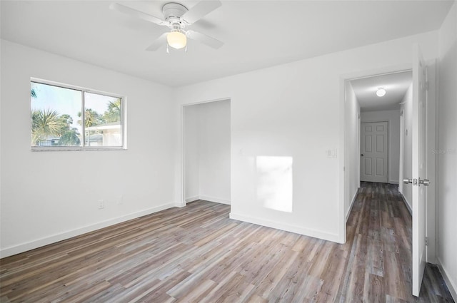 spare room featuring wood-type flooring and ceiling fan