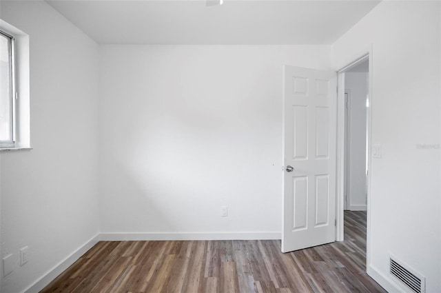 empty room with hardwood / wood-style flooring