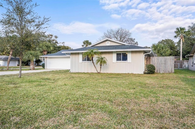 ranch-style house featuring a garage and a front lawn