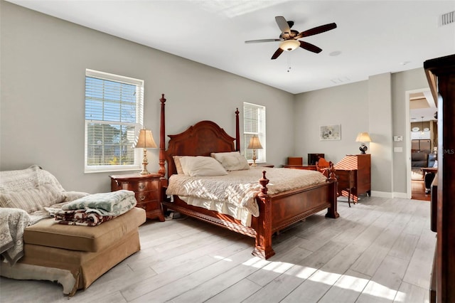 bedroom with light hardwood / wood-style floors and ceiling fan