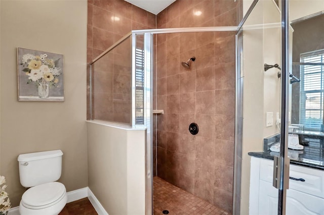 bathroom with toilet and a shower with shower door