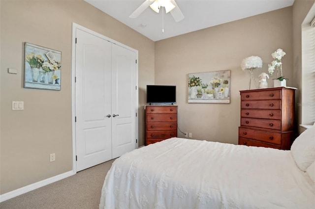 carpeted bedroom with ceiling fan and a closet