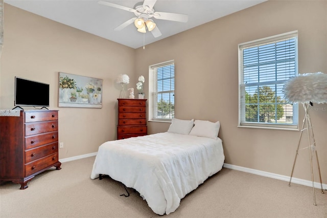 bedroom with ceiling fan and light carpet