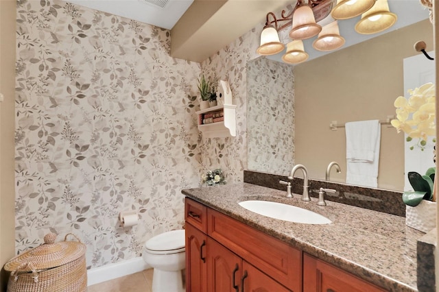 bathroom featuring vanity, tile patterned floors, and toilet