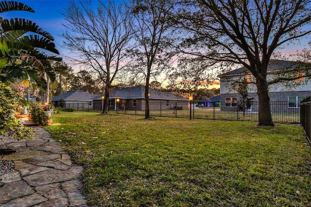 view of yard at dusk