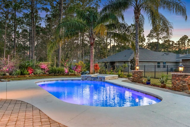 pool at dusk with a patio