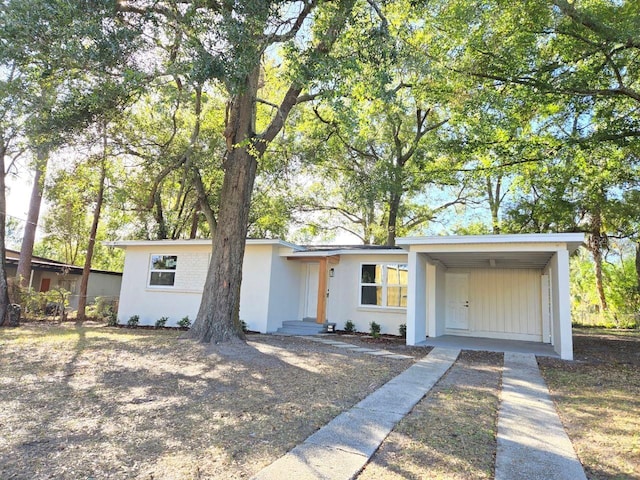 view of front of property featuring a carport