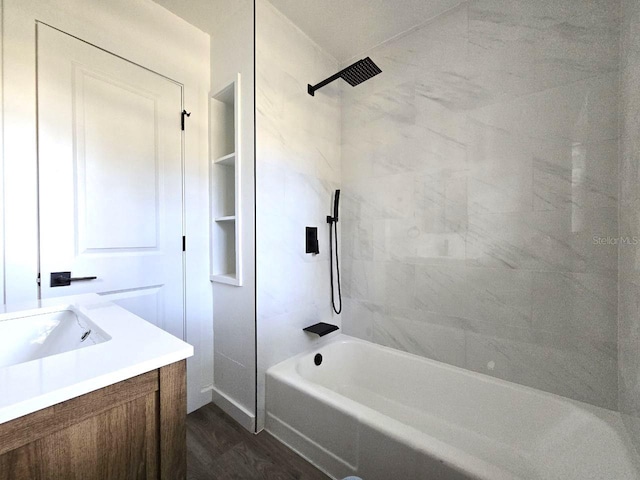 bathroom featuring vanity, hardwood / wood-style floors, and tiled shower / bath