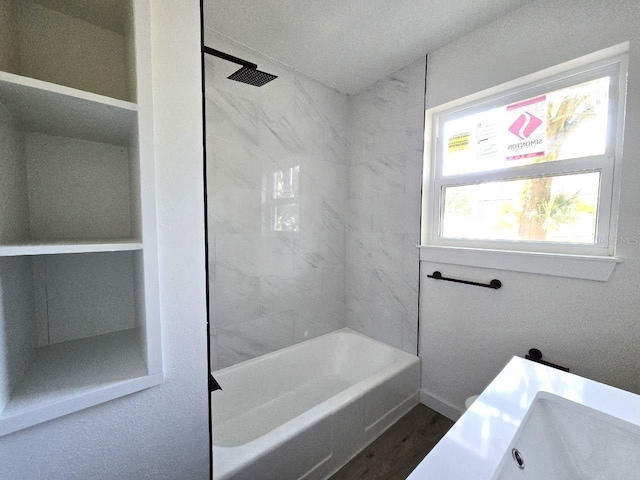 bathroom with tiled shower / bath and wood-type flooring