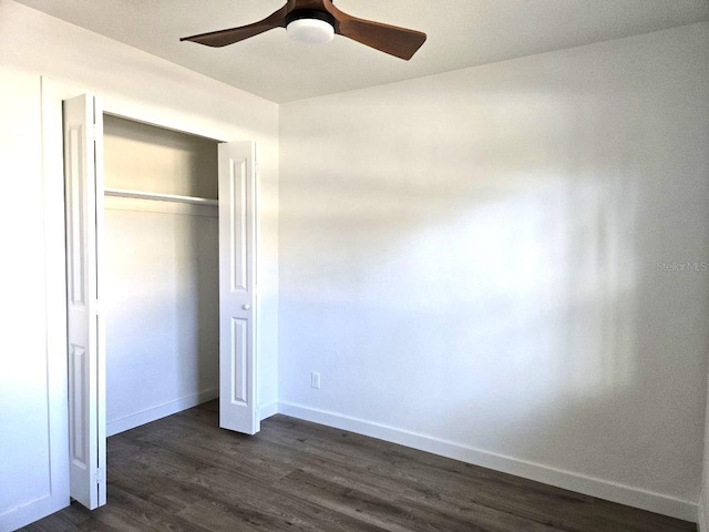 unfurnished bedroom featuring dark hardwood / wood-style flooring, a closet, and ceiling fan